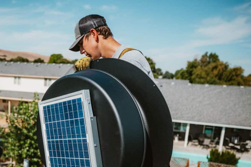 Roof Maxx of Tri-Cities crew holding a solar roof vents