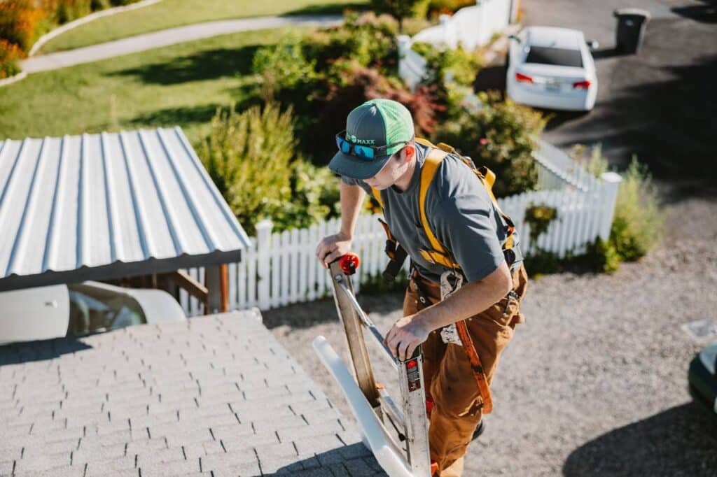 one of our team get to the roof for inspection Roof Maxx of Tri-Cities